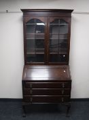 An Edwardian mahogany bureau bookcase on claw and ball feet