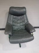 A twentieth century green leather swivel armchair