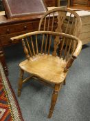 A nineteenth century elm Windsor armchair, width 61 cm.