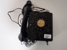 A black Bakelite cased wall mounted telephone
