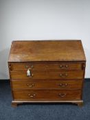 An early Victorian inlaid mahogany writing bureau on bracket feet