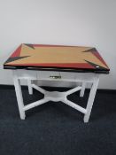 A mid 20th century extending kitchen table on a painted base