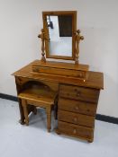 A pine dressing table fitted four drawers with mirror and stool
