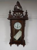 A 31 day wall clock together with an oak granddaughter clock