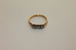 An 18ct gold three stone diamond ring