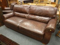 A brown leather three seater settee, width 218 cm, together with the matching armchair.