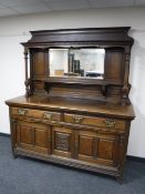 An Edwardian oak Arts and Crafts mirror back sideboard