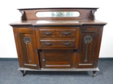 An Edwardian mahogany Art Nouveau breakfront sideboard