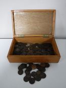 A wooden box containing a collection of Georgian pennies and assorted coinage