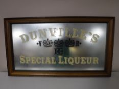 A reproduction framed Dunville's Special Liqueur advertising mirror