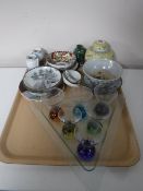 A tray containing six coloured glass shot glasses on a triangular server,
