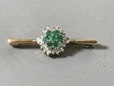 A 9ct gold diamond and emerald cluster bar brooch
