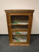 A glazed pine cabinet,