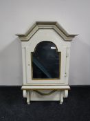 A cream and gilt wall clock case in the form of a cabinet