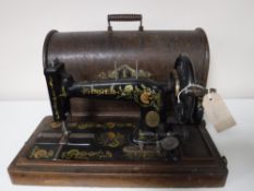 An oak cased mid 20th century Singer hand sewing machine