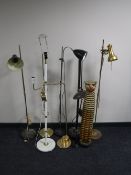 Seven late 20th century metal floor lamps together with a wooden figure of a tiger