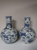 A large pair of Chinese blue and white bulbous vases with dragon decoration,