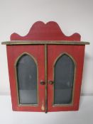 A painted double door wall cabinet