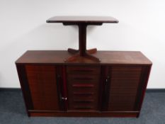 A sideboard in a mahogany finish together with a mahogany coffee table