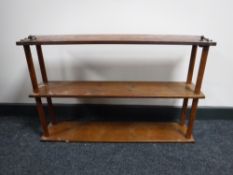 A mahogany three tier wall shelf