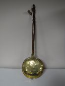 A copper and brass bed warming pan