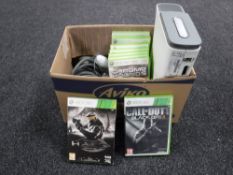 A box containing Xbox 360 with leads controller and games