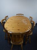 An oval pine extending table fitted a leaf together with six chairs