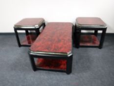 An Oriental style two tier coffee table together with a pair of matching lamp tables