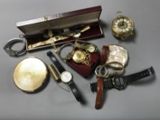 A box containing assorted ladies and gents wrist watches, two compacts, a travel alarm clock,