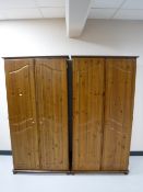 A pair of pine double door wardrobes