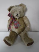 A mid 20th century jointed teddy bear with growler