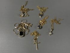 Six 9ct gold necklaces and pendants - one set with blue sapphire and diamonds.