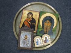 A large brass embossed wall plaque together with four religious icons