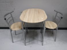 A kitchen table with two stowaway chairs