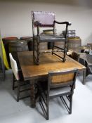 An oak early 20th century pull out table and four chairs