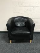A faux leather tub chair