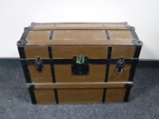 A dome topped metal bound shipping trunk