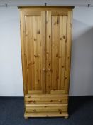 A pine double door wardrobe fitted two drawers