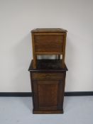 An oak cabinet and a commode stool