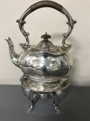 A good quality silver plated spirit kettle on stand with burner.