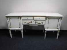 A white and gilt Regency style inverted breakfront sideboard