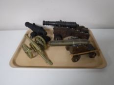 A tray containing four ornamental cannons