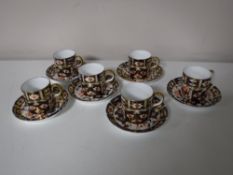 Six Royal Crown Derby Imari coffee cans with saucers,