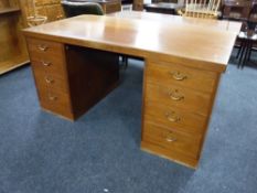 A mid 20th century teak twin pedestal desk