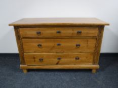 An early 20th century stained pine three drawer chest