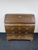 A 19th century oak shaped-front writing bureau