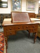 A Victorian mahogany writing desk with inset leather top,