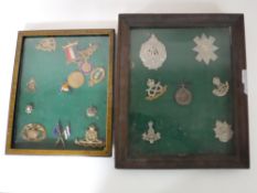 A collection of WWI medals, military cap badges, coronation medal,