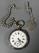 A silver pocket watch with silver Albert and medal.