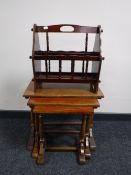 A nest of three oak tables together with a magazine rack